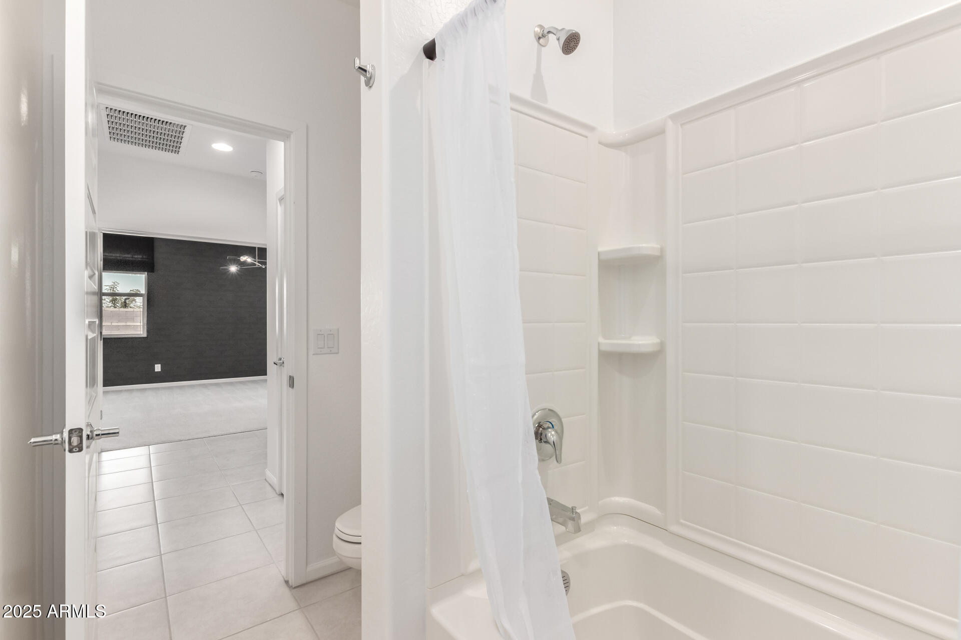 12524 West Trumbull Road Avondale, AZ 85323 - Photo 24 of 34 a bathroom with a bathtub and a shower