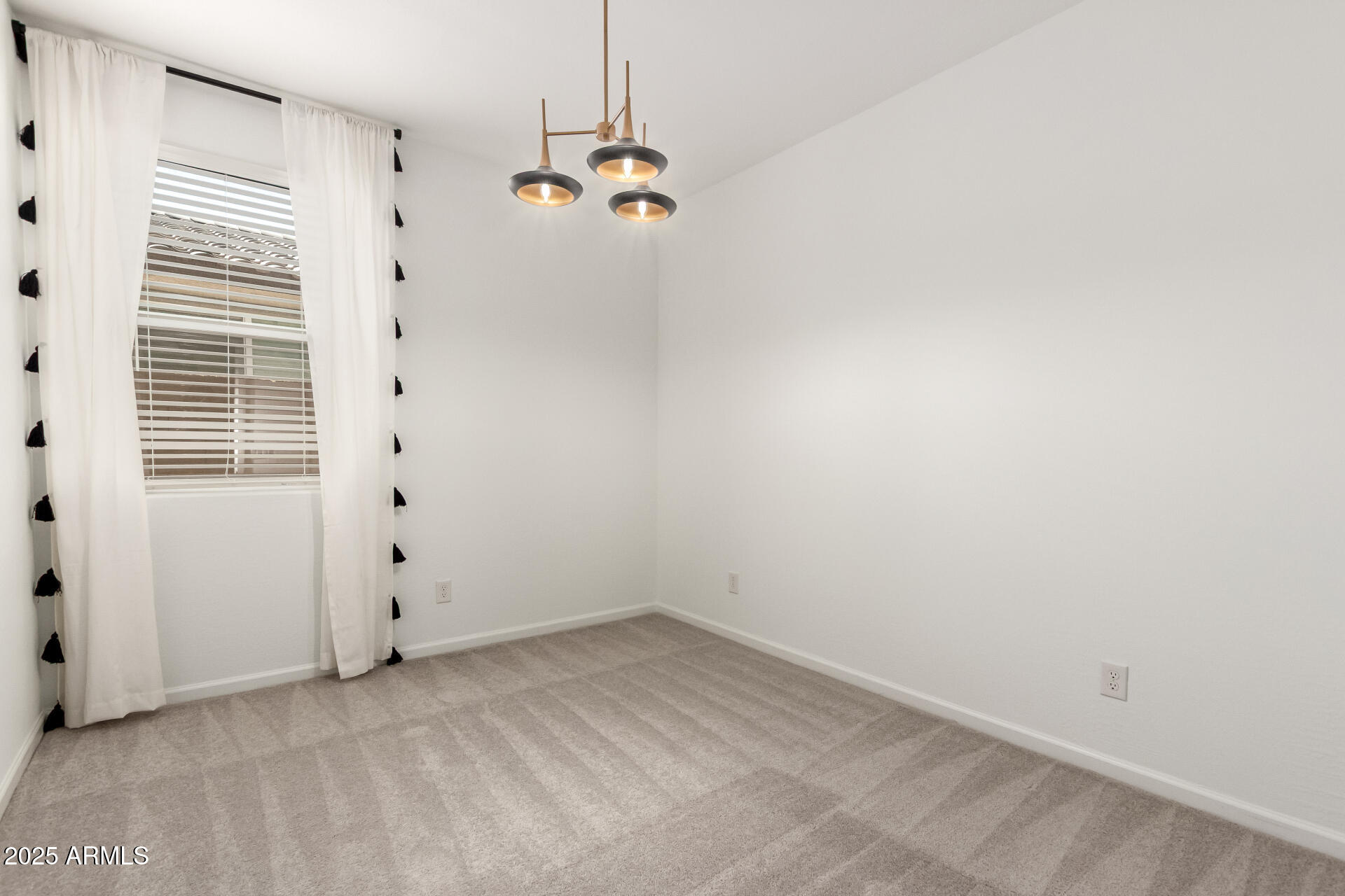 12524 West Trumbull Road Avondale, AZ 85323 - Photo 25 of 34 an empty room with chandelier fan