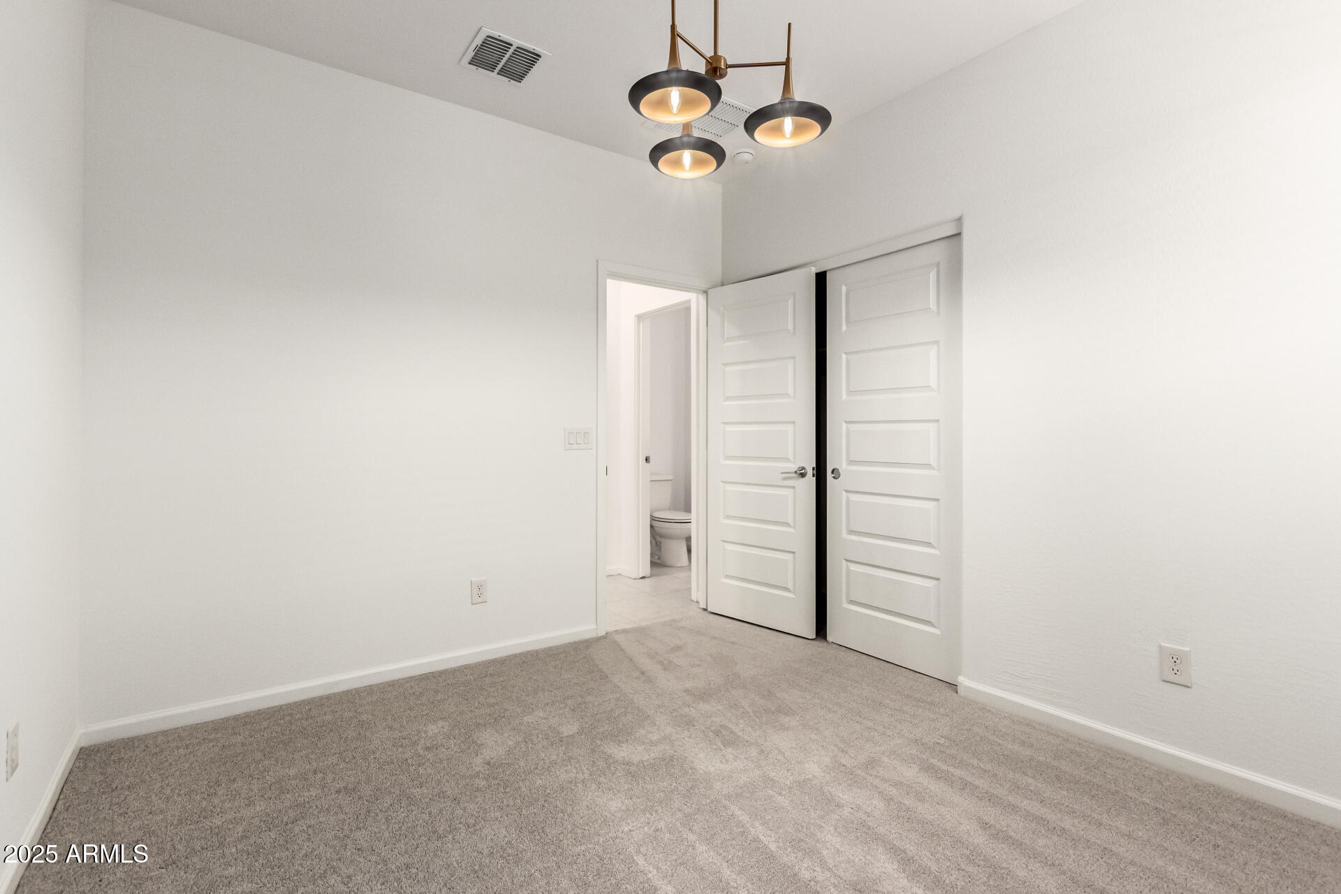 12524 West Trumbull Road Avondale, AZ 85323 - Photo 26 of 34 an empty room with windows and ceiling fan