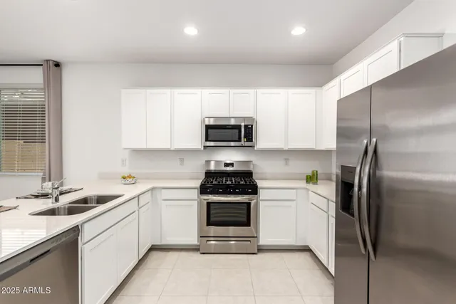 a kitchen with a sink a stove and refrigerator