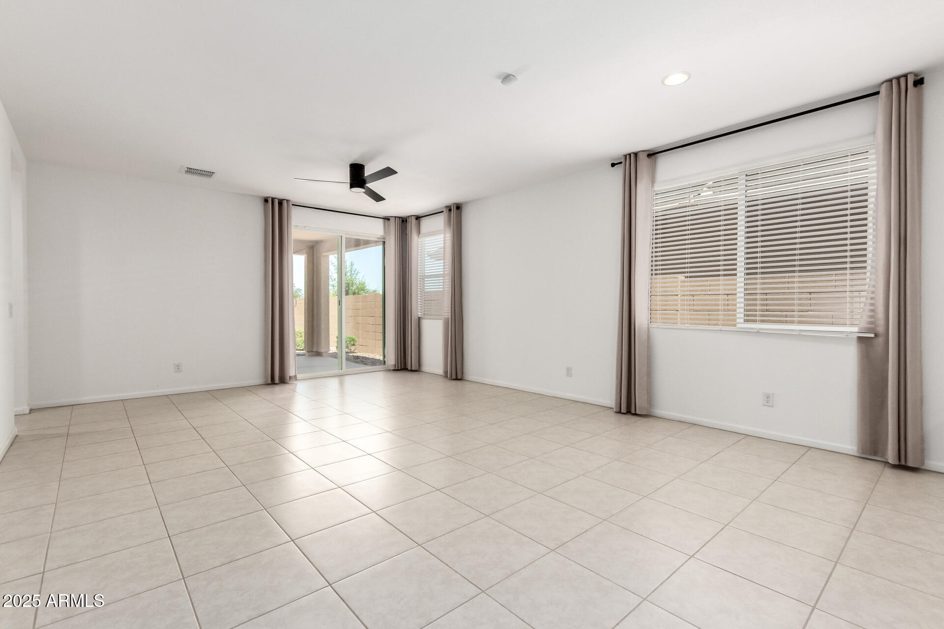 12524 West Trumbull Road Avondale, AZ 85323 - Photo 7 of 34 a view of an empty room with a window