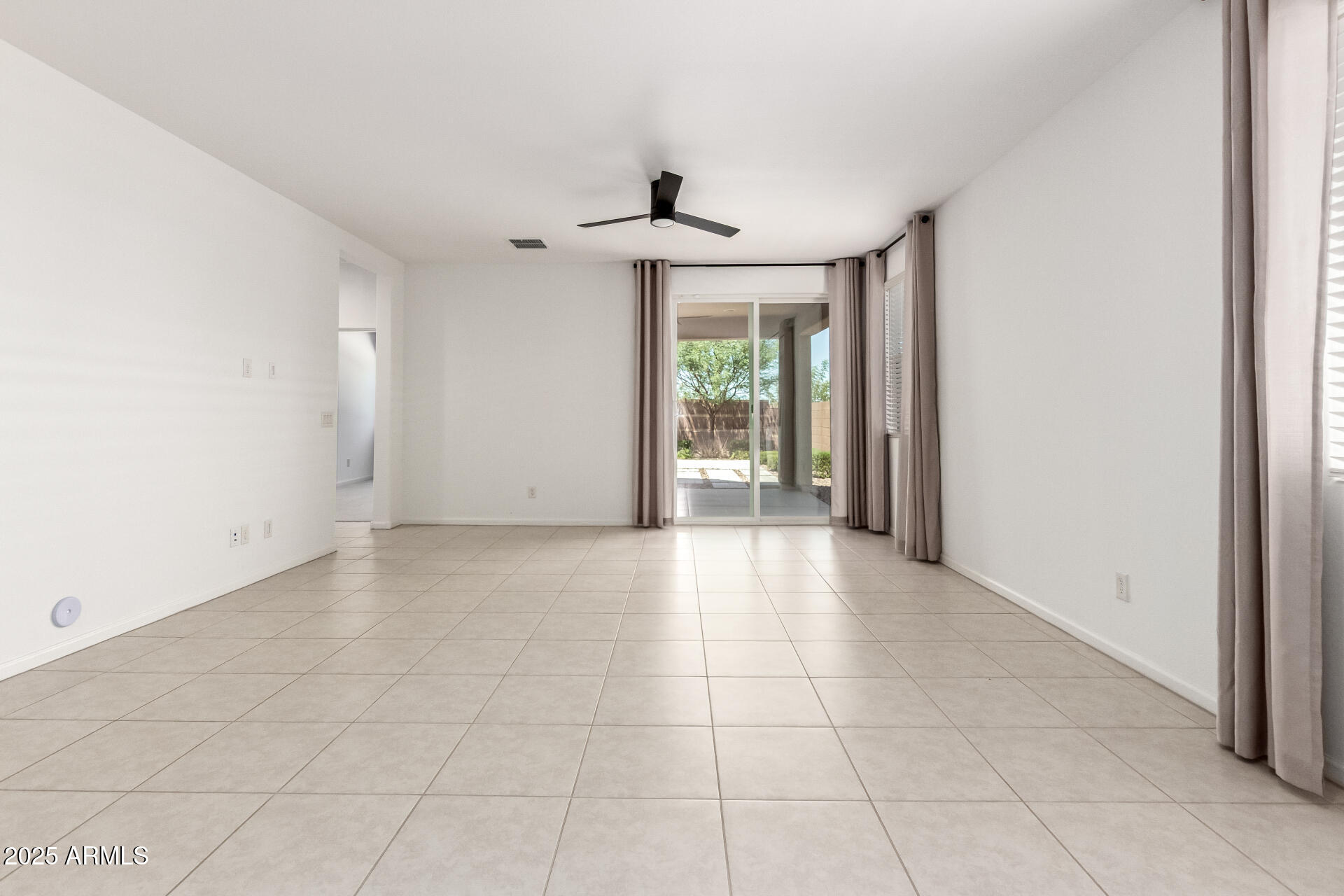 12524 West Trumbull Road Avondale, AZ 85323 - Photo 8 of 34 a view of an empty room with a window
