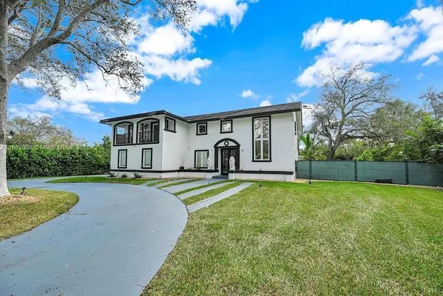 a spacious bedroom with a bed next to a large window with the outer view