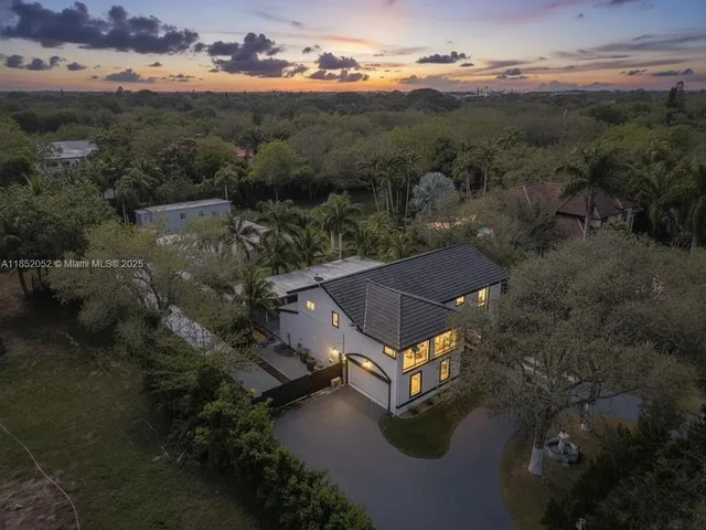 a kitchen with stainless steel appliances granite countertop a refrigerator sink and white cabinets