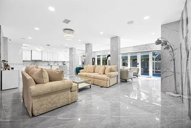 a bedroom with furniture and a large window