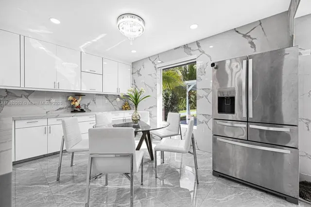 a kitchen with stainless steel appliances a refrigerator sink and cabinets