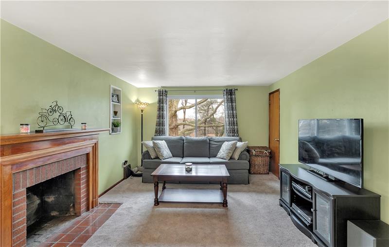 Another View of the Living Room with a Large Picture Window Looks Out Over the Back Yard.  In the Far Right Corner is a Storage/Coat Closet.