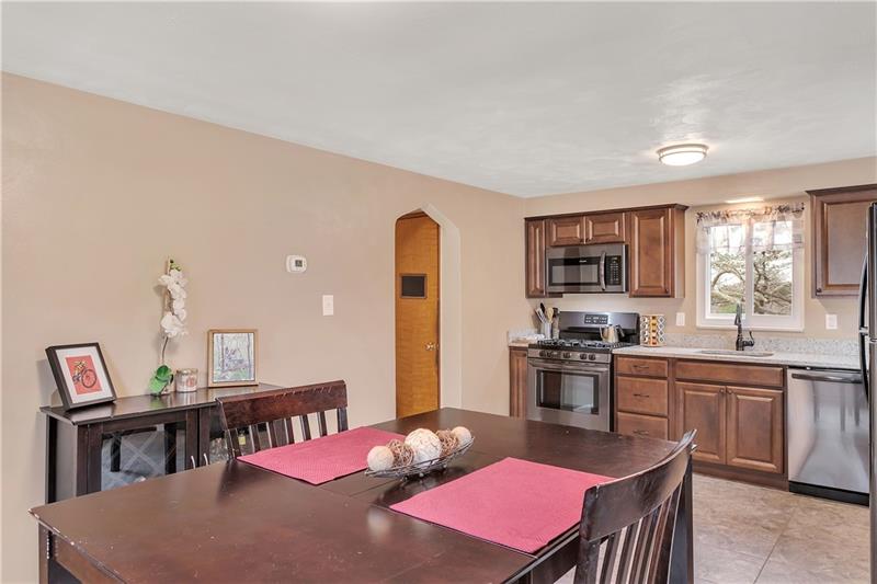 6333 Verona Road Verona, PA 15147 - Photo 10 of 25 Another View of the Open Dining Room / Kitchen. In the Left Corner Through the Arched Doorway is a Nice Size Pantry, and Steps to the Basement/Lower Level.