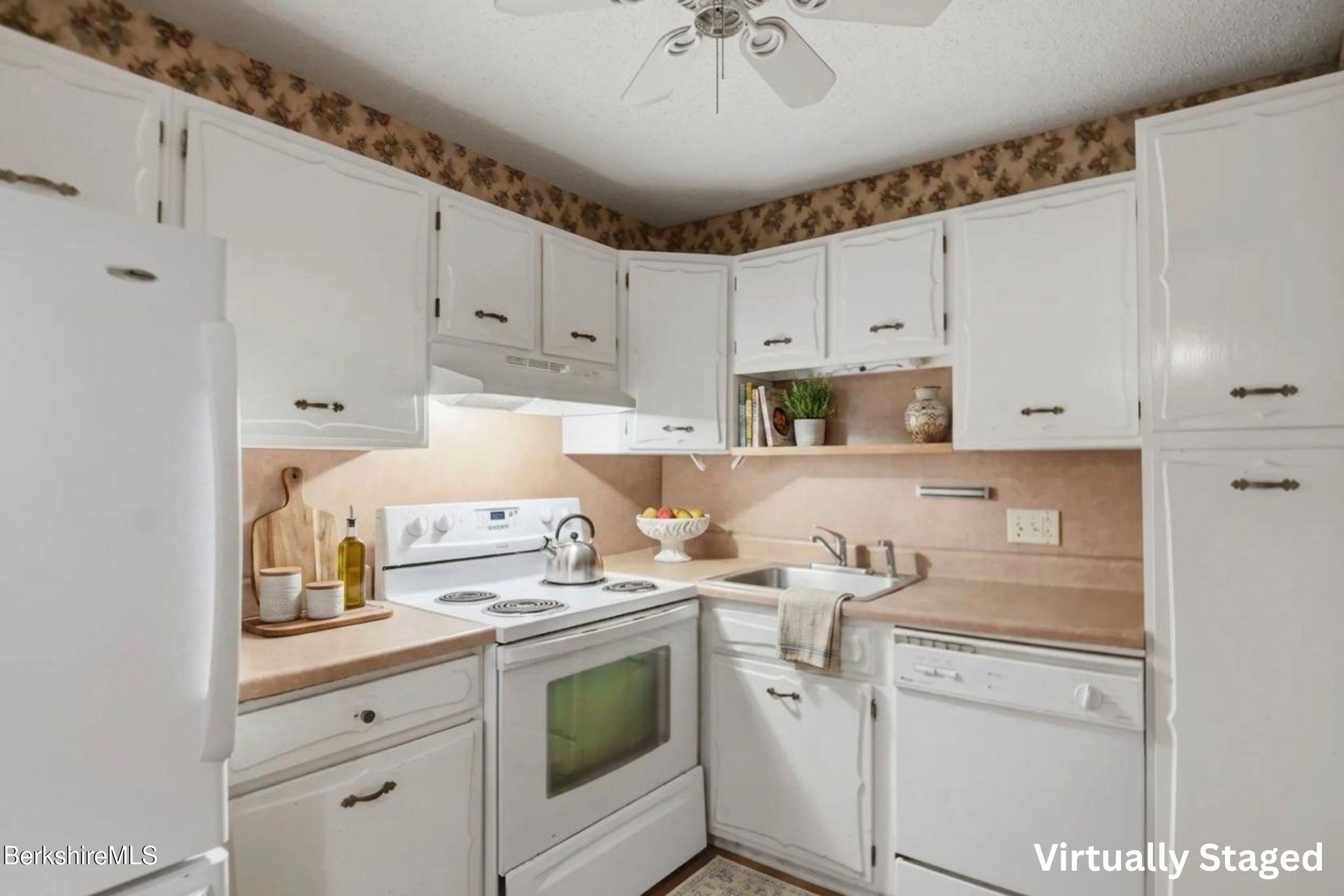 1 Colt Road, Unit 1 Pittsfield, MA 01201 - Photo 12 of 28 a kitchen with a sink a stove cabinets and white appliances