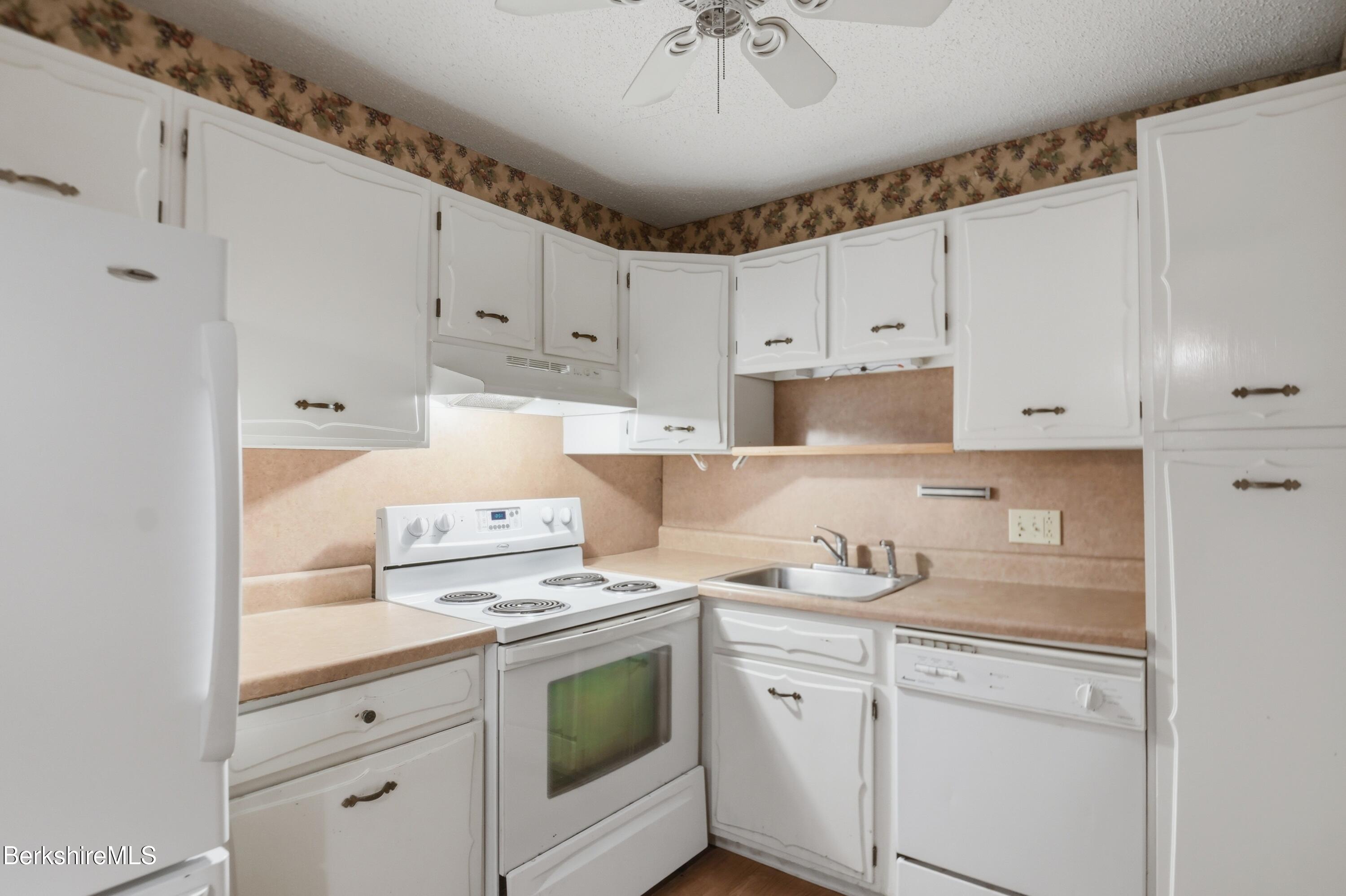 1 Colt Road, Unit 1 Pittsfield, MA 01201 - Photo 13 of 28 a kitchen with granite countertop white cabinets and white appliances