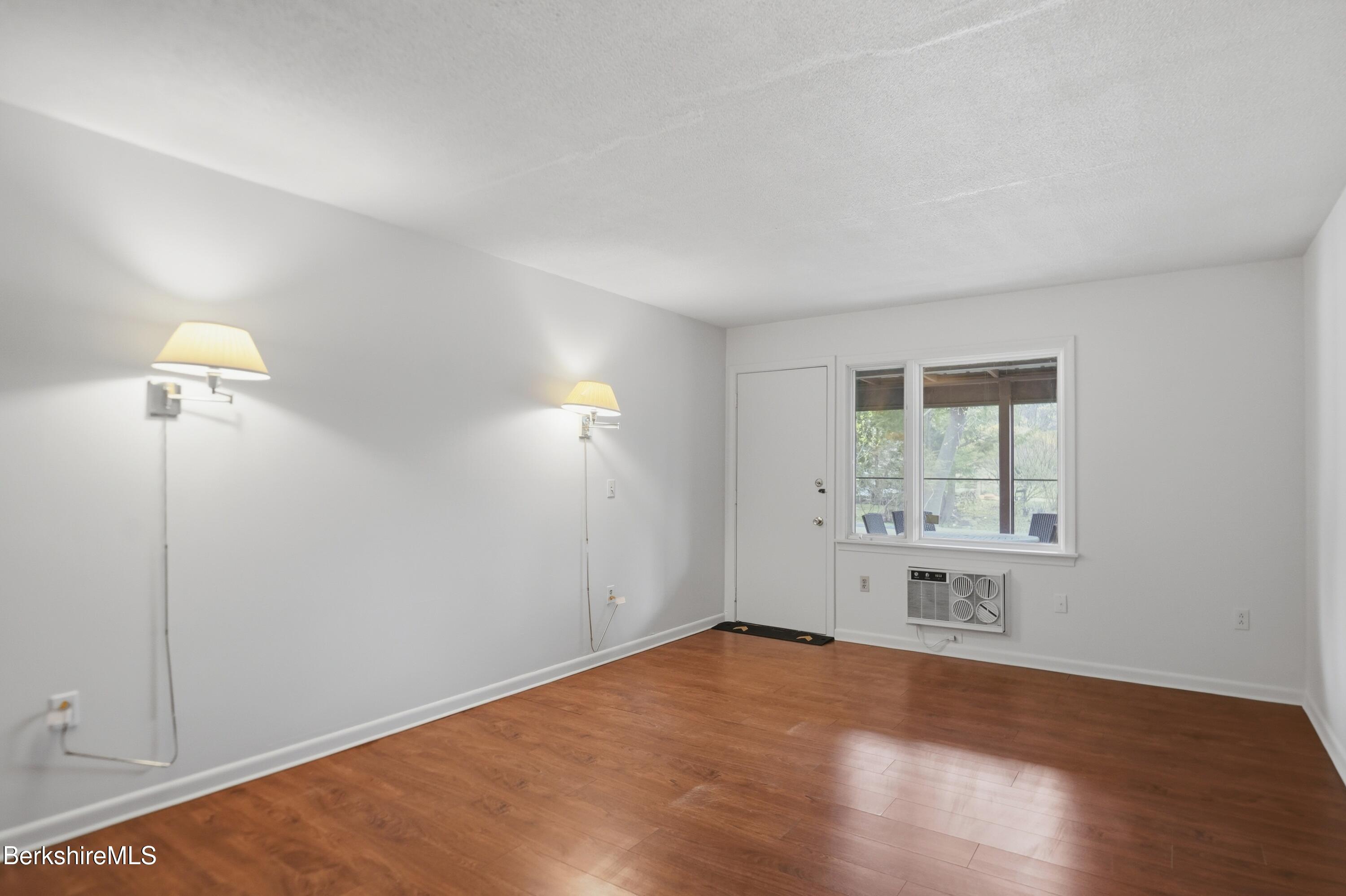 1 Colt Road, Unit 1 Pittsfield, MA 01201 - Photo 20 of 28 an empty room with wooden floor and windows
