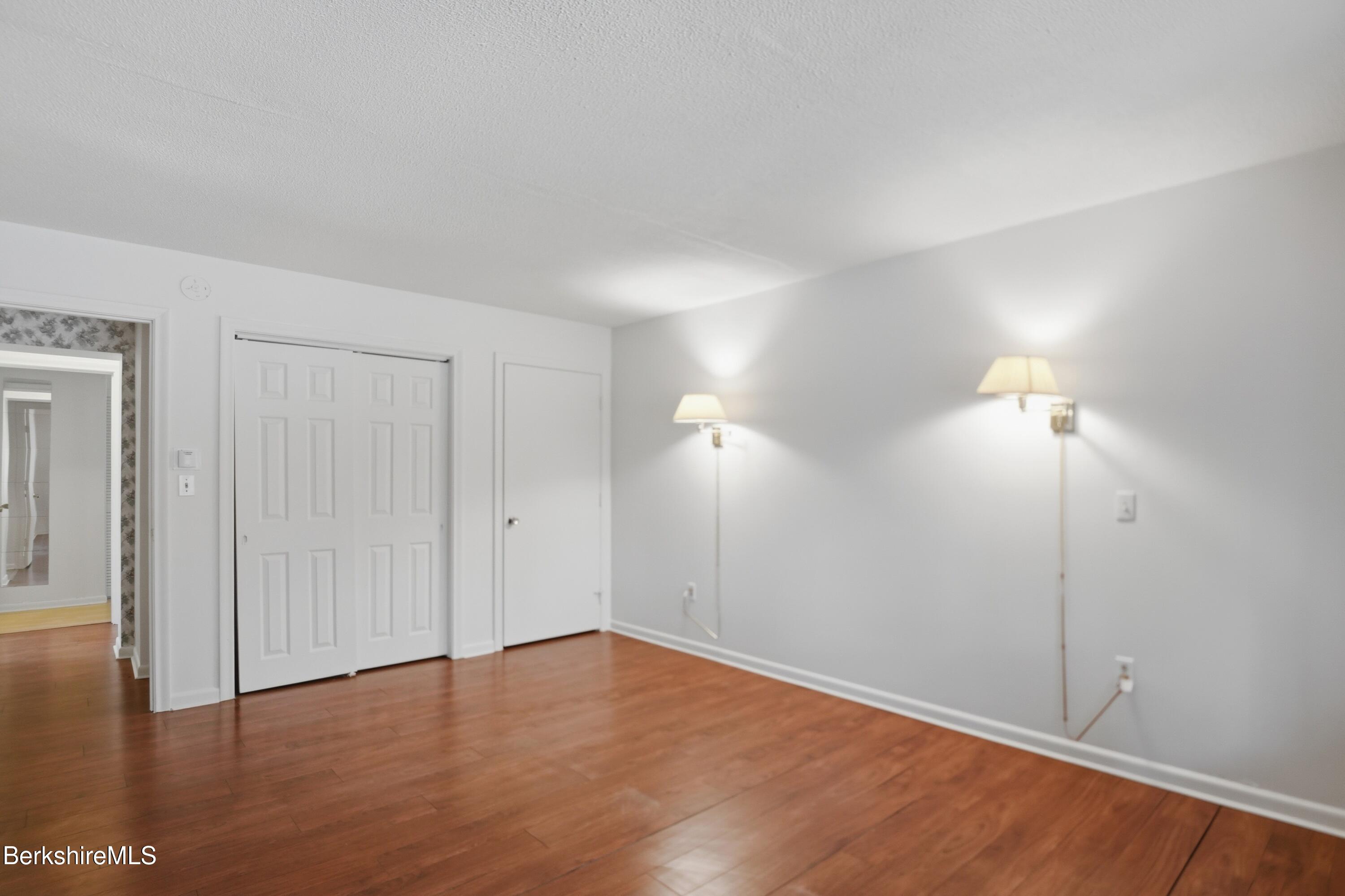 1 Colt Road, Unit 1 Pittsfield, MA 01201 - Photo 22 of 28 a view of an empty room with wooden floor and a window
