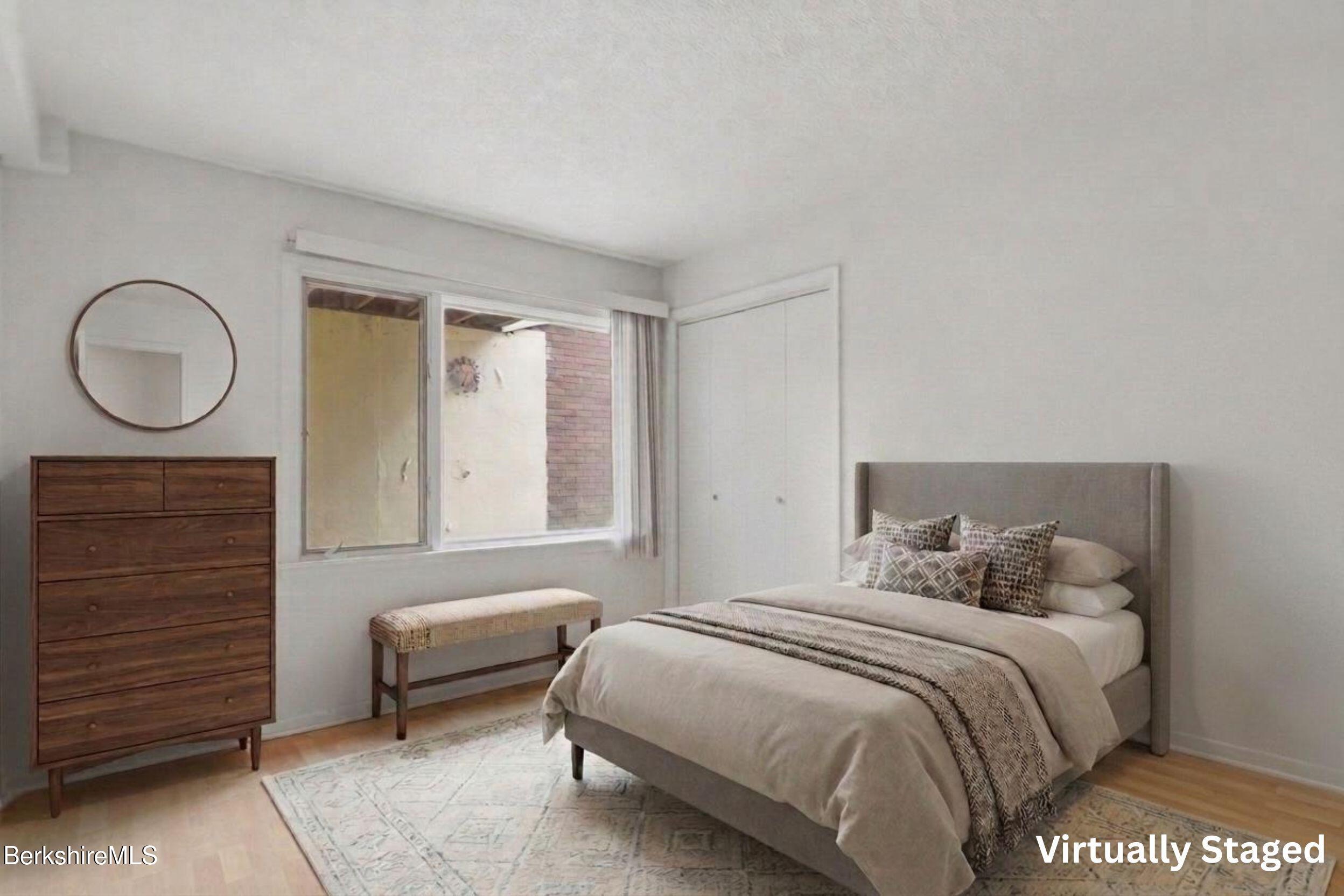 1 Colt Road, Unit 1 Pittsfield, MA 01201 - Photo 24 of 28 a bedroom with a bed and a cabinets