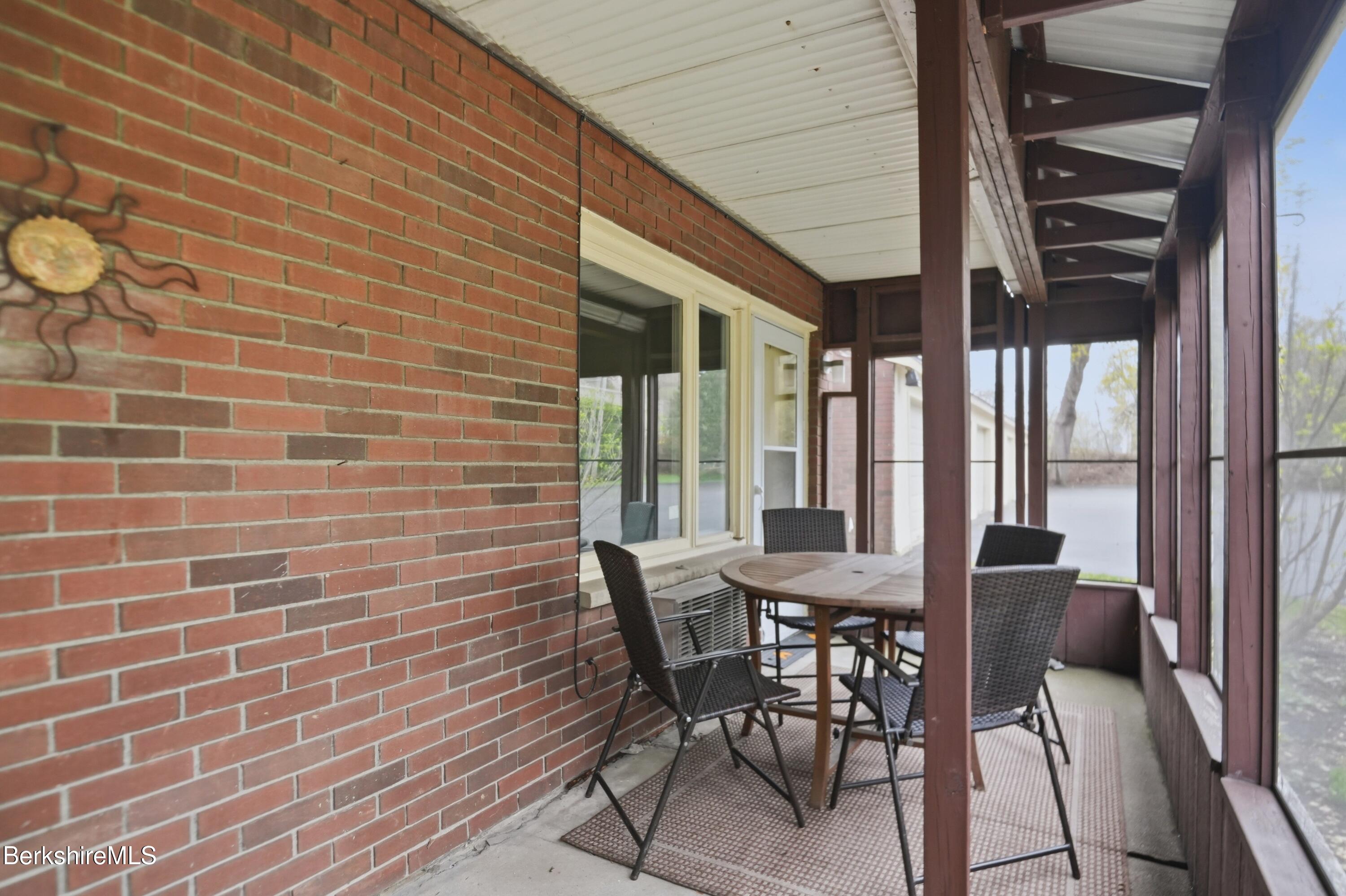 1 Colt Road, Unit 1 Pittsfield, MA 01201 - Photo 27 of 28 a view of a patio with table and chairs and potted plants