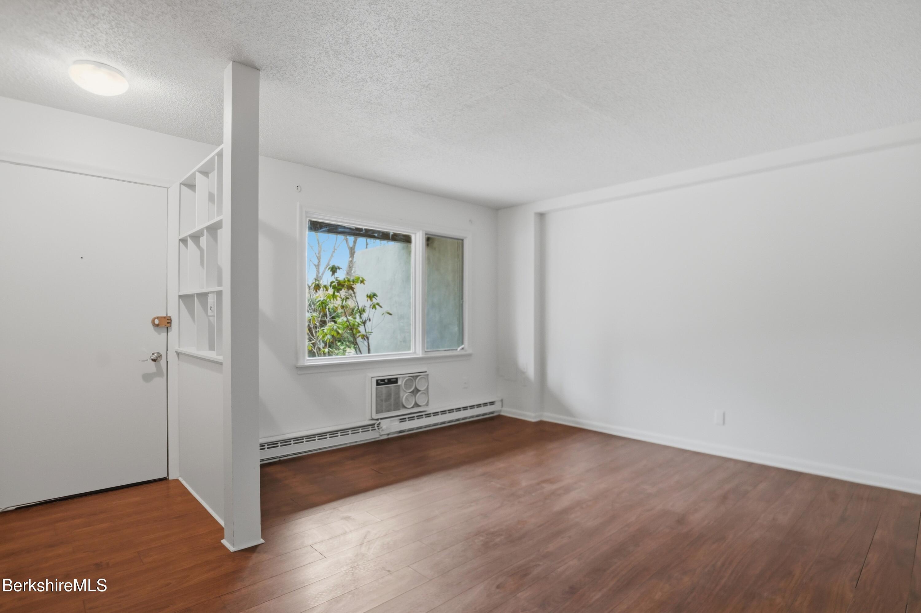 1 Colt Road, Unit 1 Pittsfield, MA 01201 - Photo 4 of 28 an empty room with wooden floor and windows