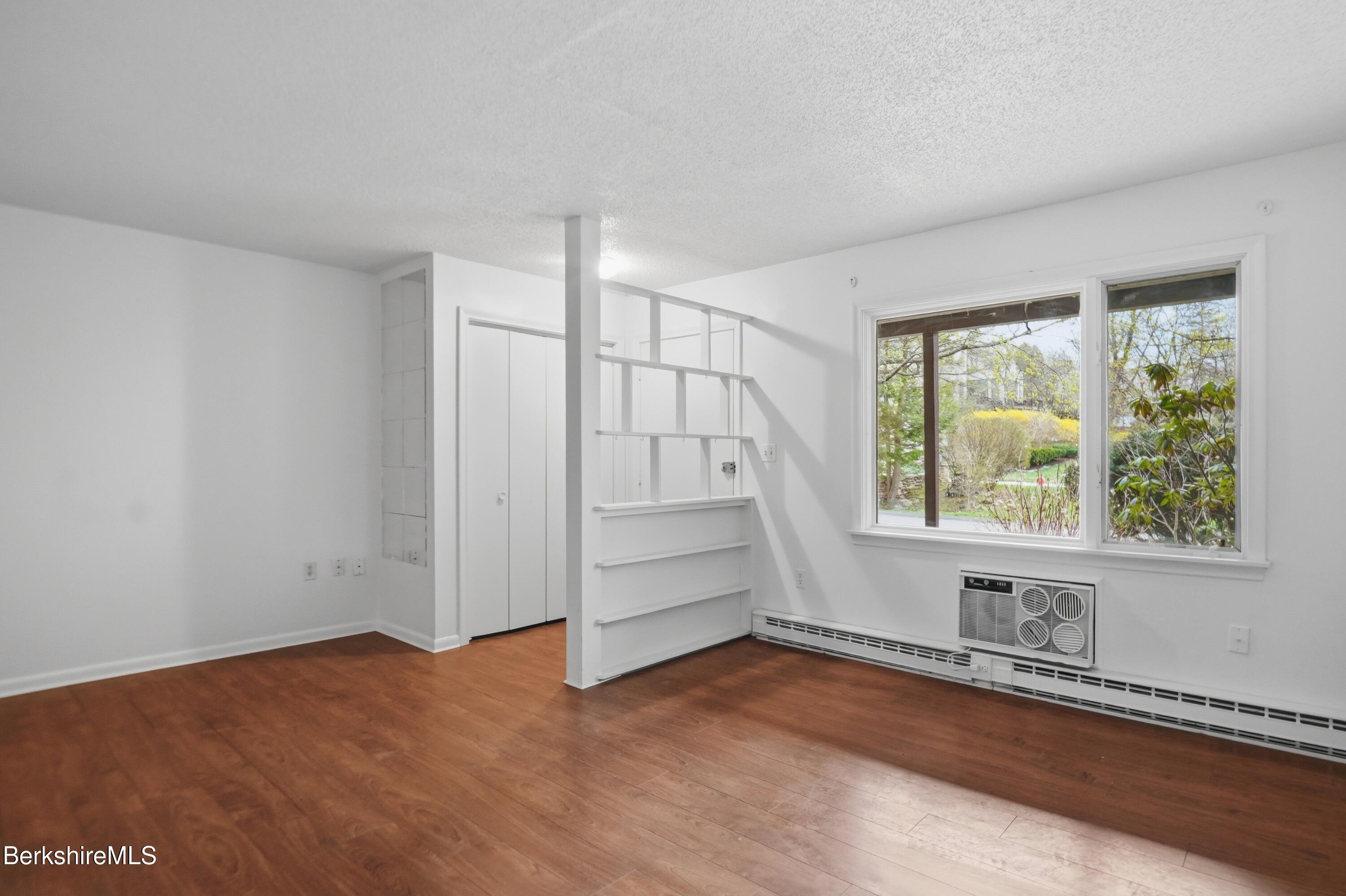 1 Colt Road, Unit 1 Pittsfield, MA 01201 - Photo 5 of 28 a view of an empty room with a window and wooden floor