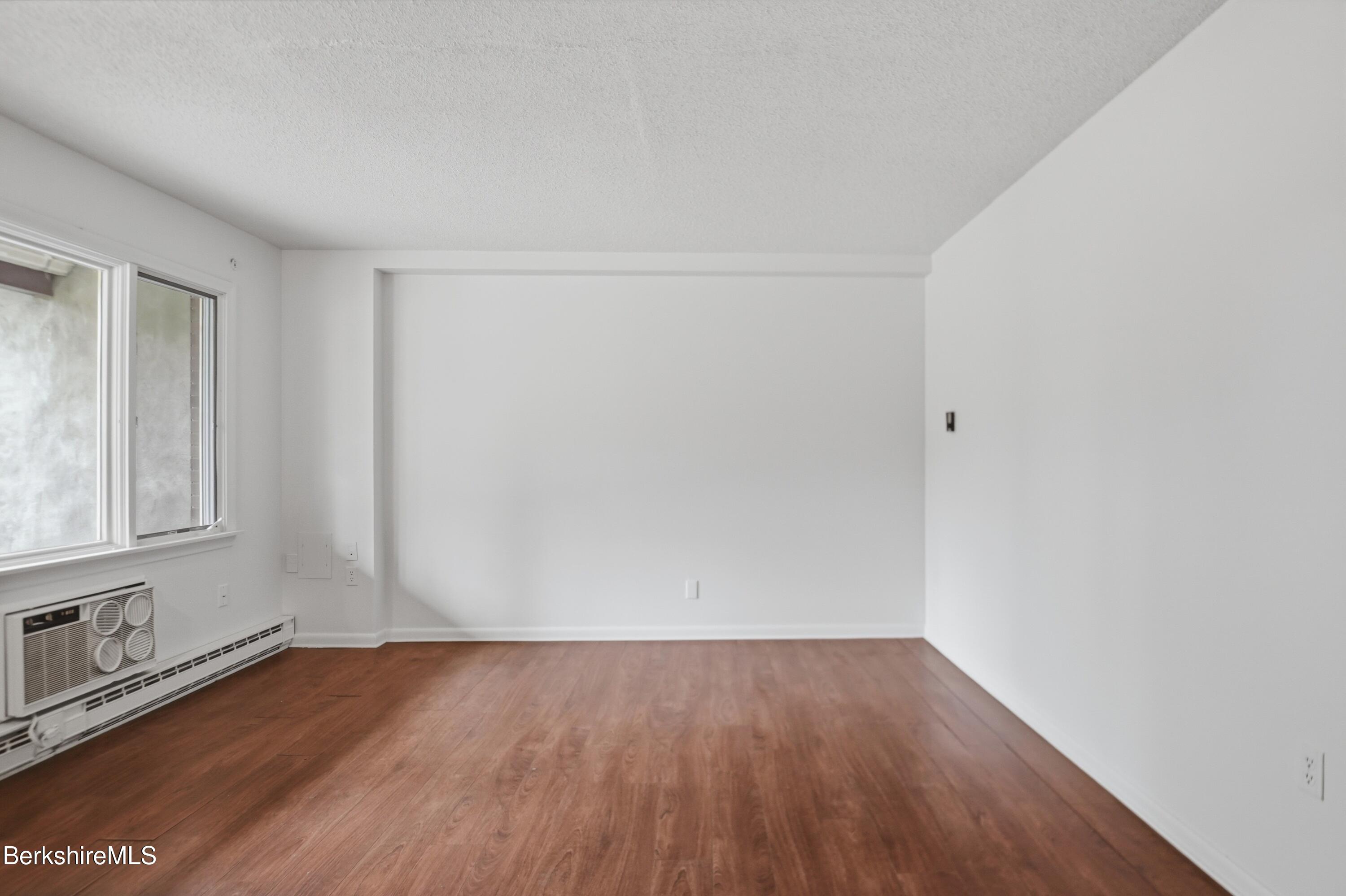 1 Colt Road, Unit 1 Pittsfield, MA 01201 - Photo 7 of 28 a view of an empty room with wooden floor and a window