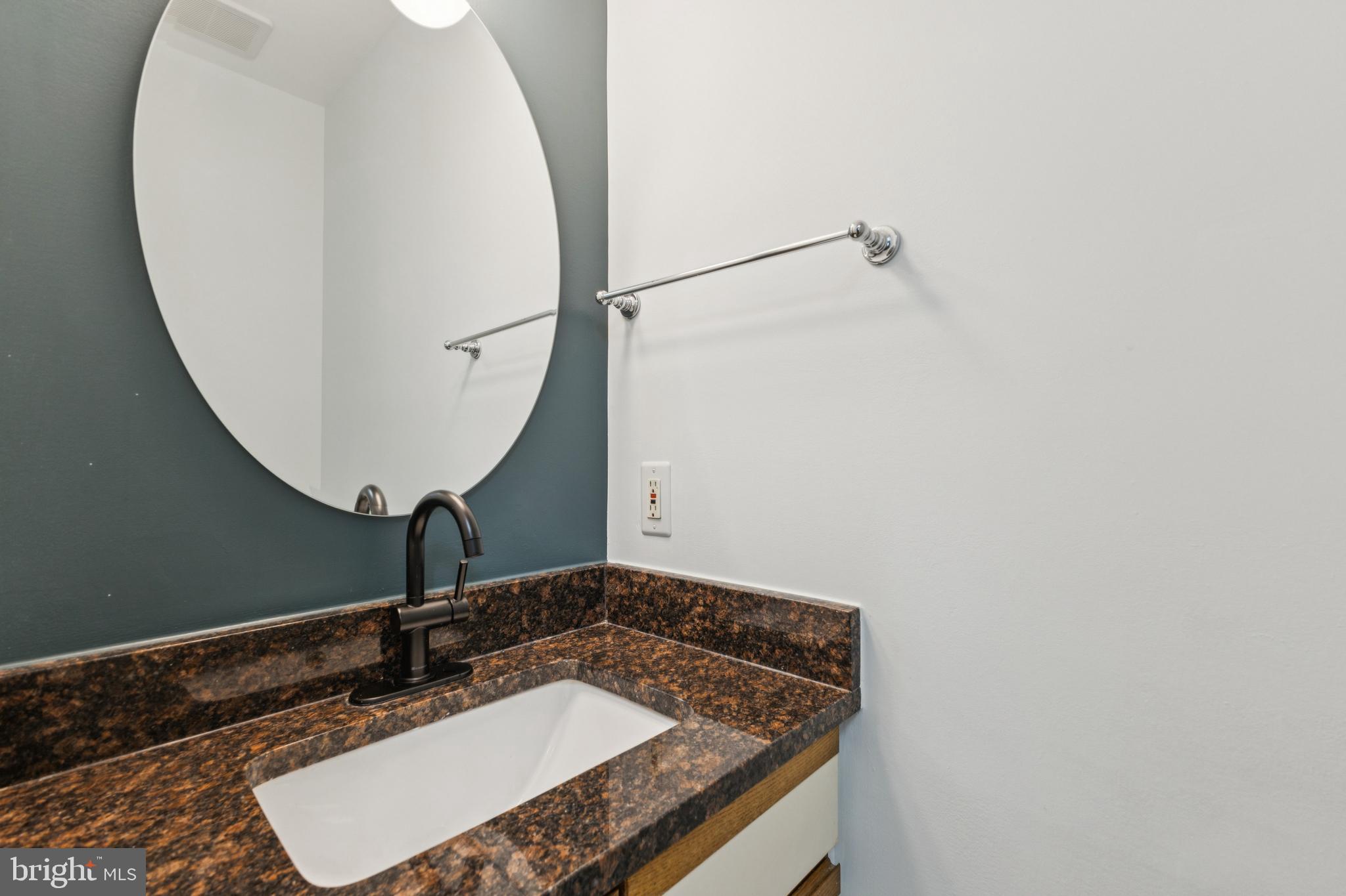 8485 Laurel Oak Drive Springfield, VA 22153 - Photo 13 of 40 a bathroom with a granite countertop sink and a mirror