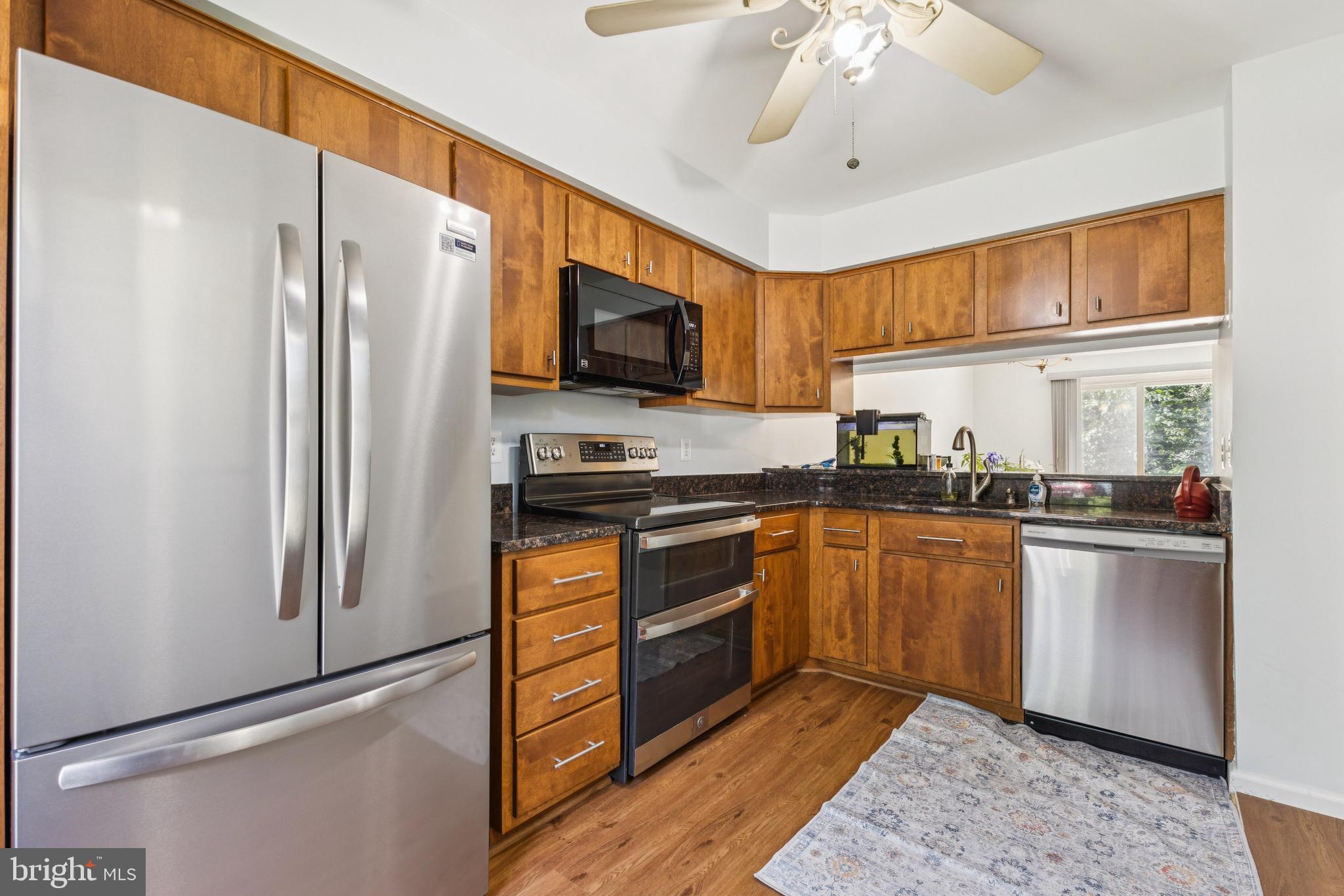 8485 Laurel Oak Drive Springfield, VA 22153 - Photo 6 of 40 a kitchen with stainless steel appliances granite countertop a refrigerator oven a sink dishwasher and a refrigerator with wooden floor