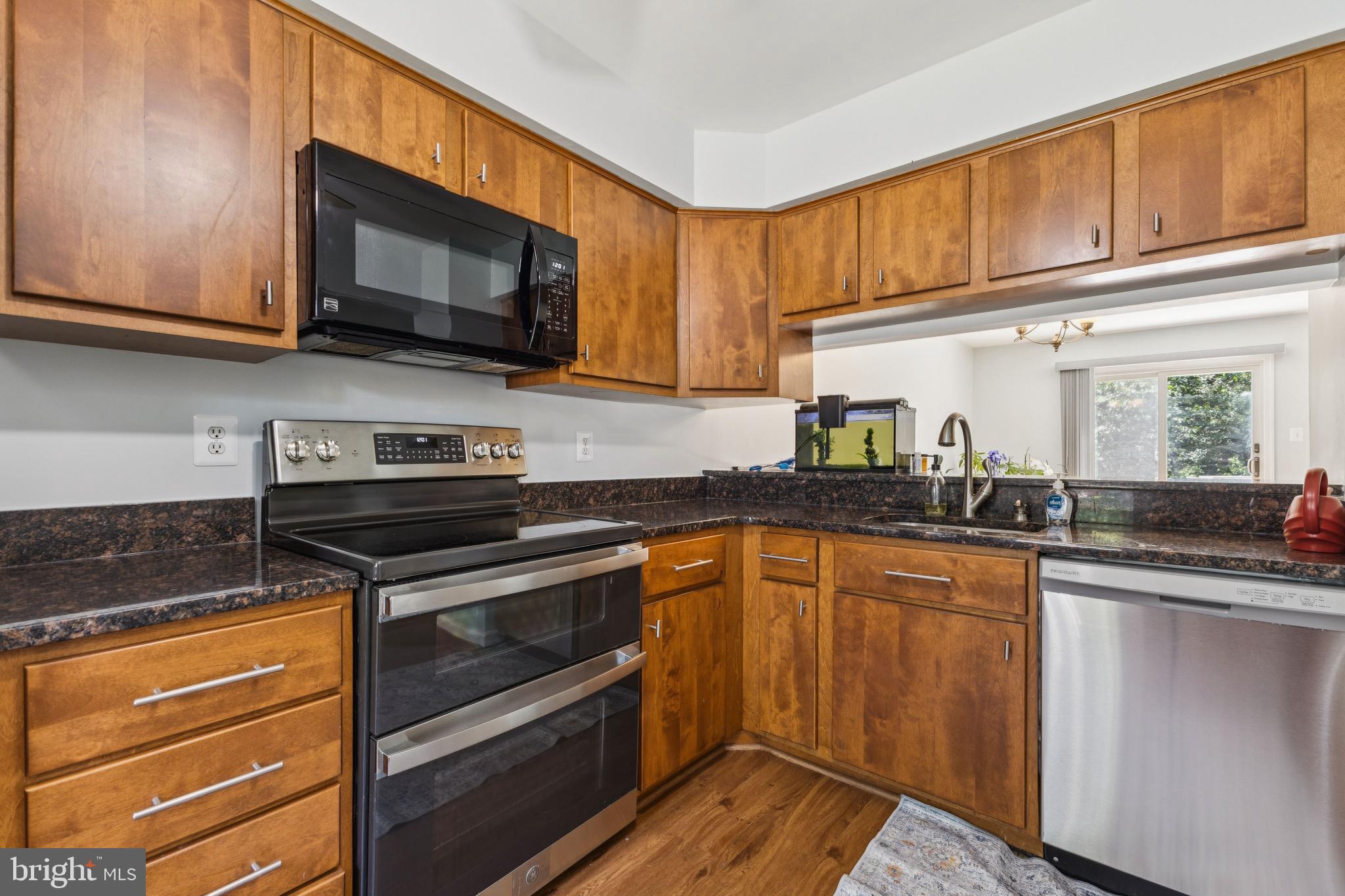 8485 Laurel Oak Drive Springfield, VA 22153 - Photo 7 of 40 a kitchen with stainless steel appliances granite countertop a stove microwave and sink