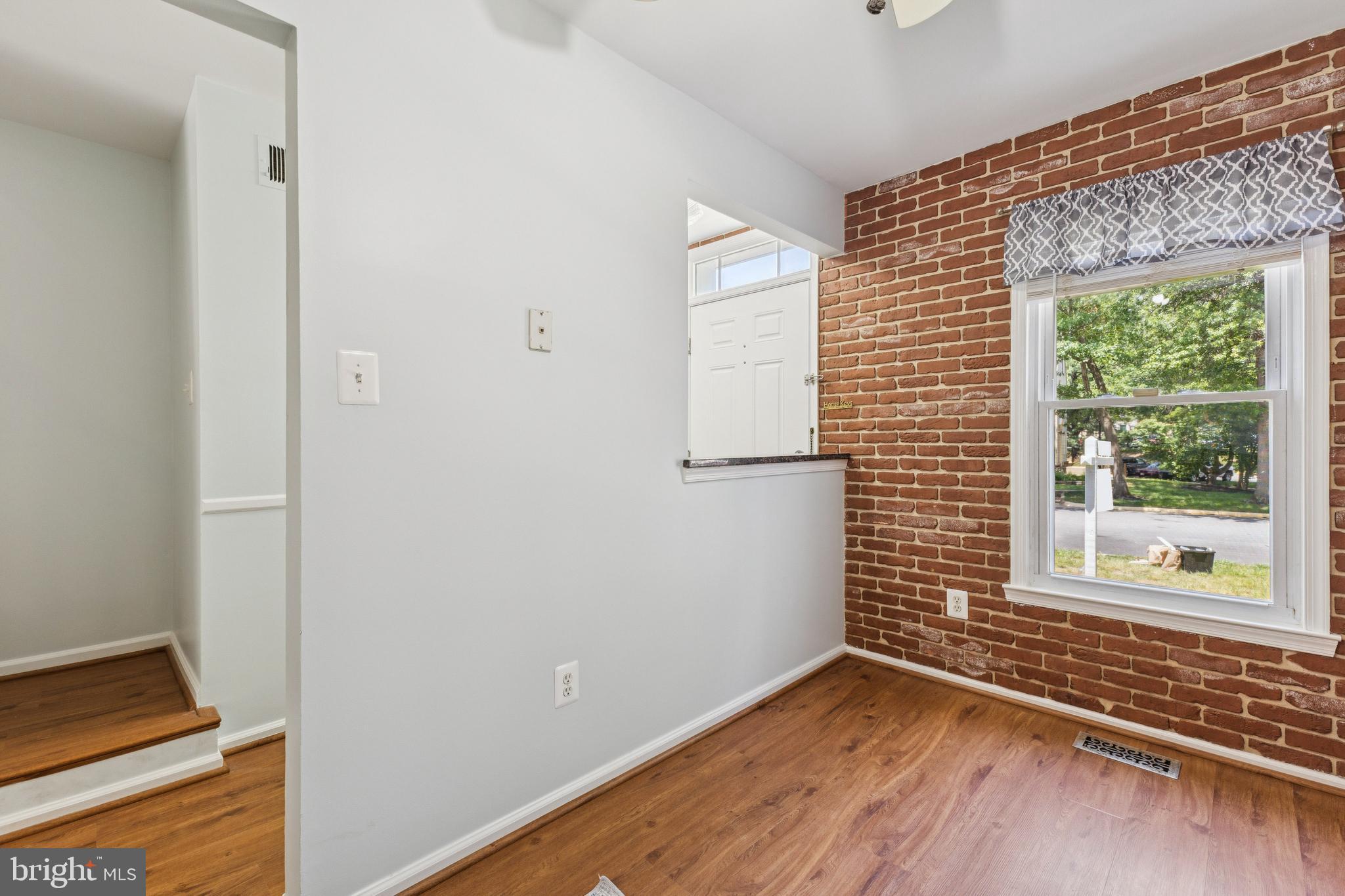 8485 Laurel Oak Drive Springfield, VA 22153 - Photo 8 of 40 a view of an empty room with wooden floor and a window