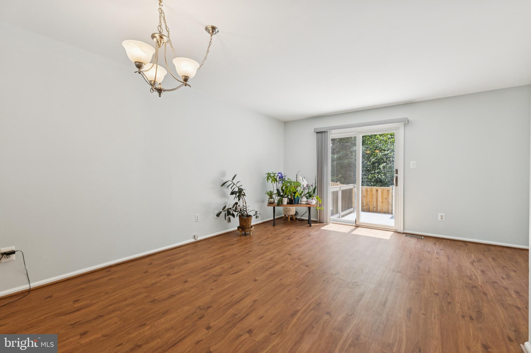 8485 Laurel Oak Drive Springfield, VA 22153 - Photo 9 of 40 an empty room with wooden floor and windows