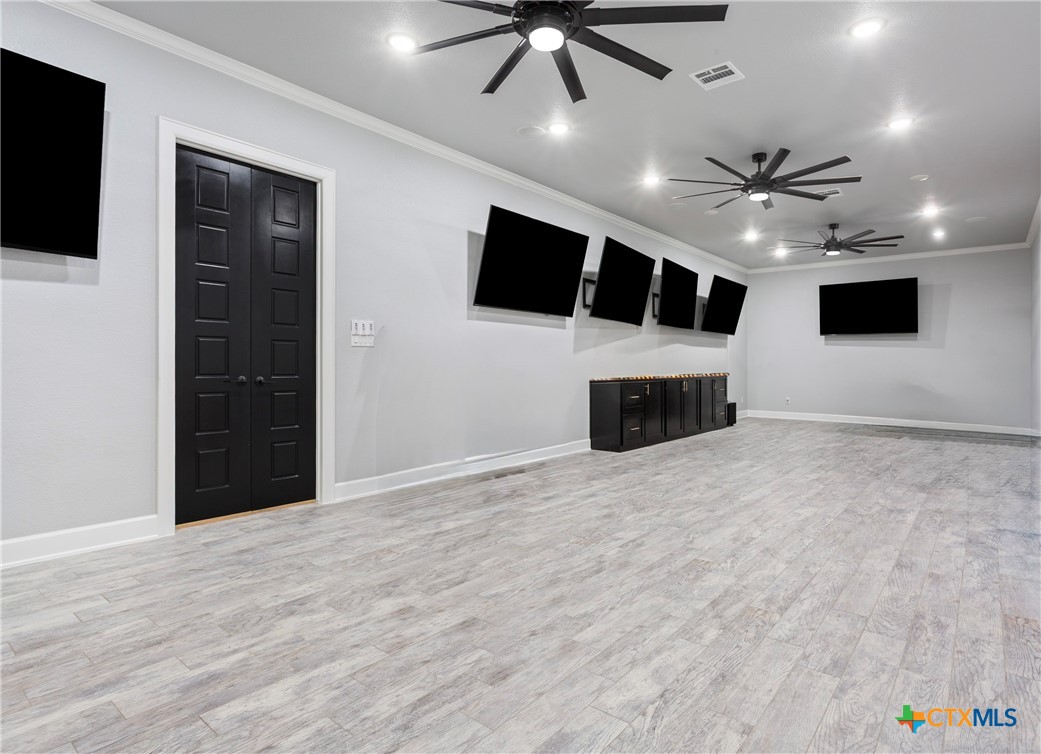 10940 Wedel Cemetery Road Rogers, TX 76569 - Photo 29 of 48 a big room with windows fireplace and a chandelier fan