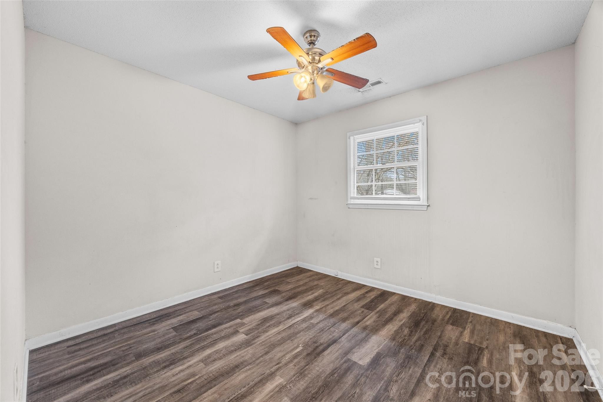 105 McGee Street Fort Mill, SC 29715 - Photo 11 of 23 an empty room with a window and a ceiling fan
