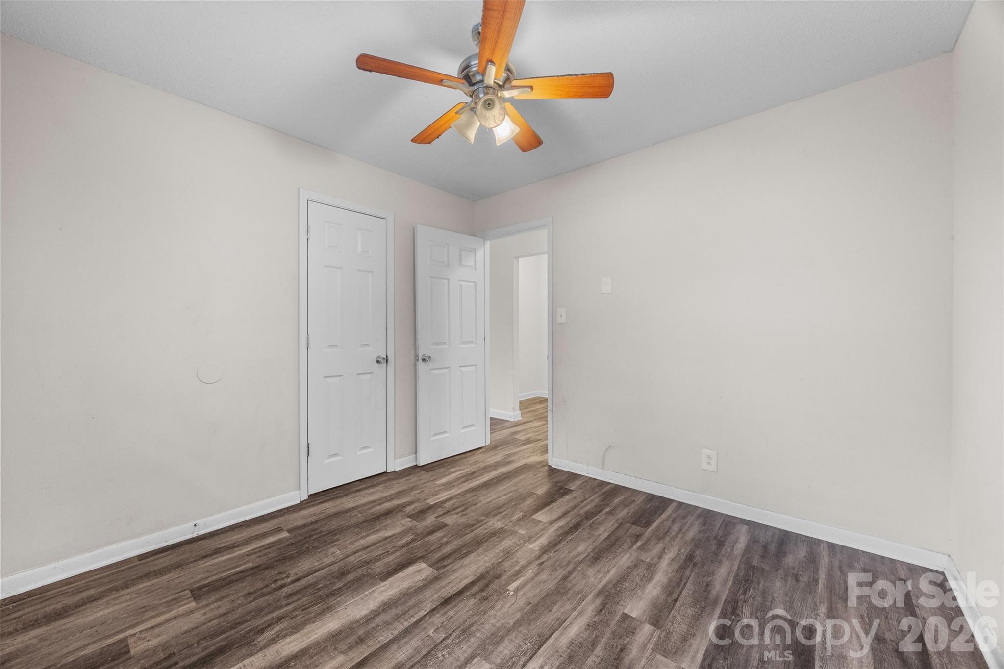 105 McGee Street Fort Mill, SC 29715 - Photo 12 of 23 a view of a room with wooden floor and a ceiling fan