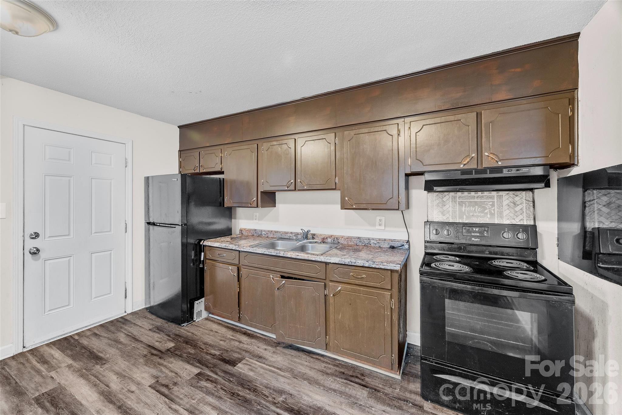 105 McGee Street Fort Mill, SC 29715 - Photo 9 of 23 a kitchen with kitchen island granite countertop stainless steel appliances and wooden cabinets