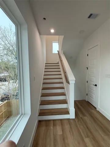 a view of entryway with wooden floor and stairs