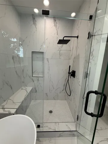 a large kitchen with kitchen island a stove a sink a center island and wooden floor