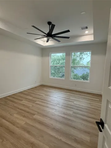 a spacious bathroom with a bathtub sink and mirror