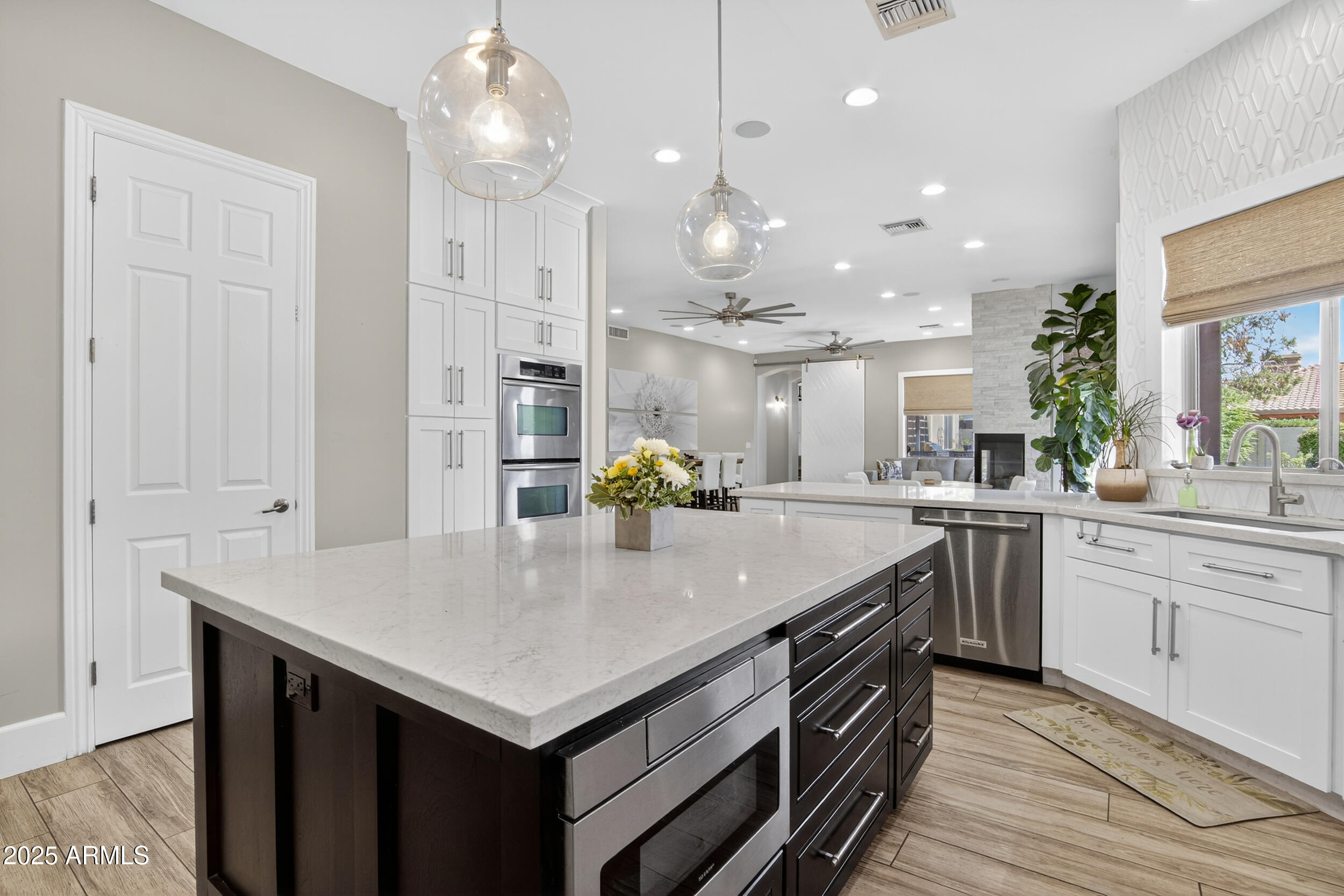 1333 North Cliffside Drive Gilbert, AZ 85234 - Photo 21 of 98 a kitchen with a stove center island a counter space and wooden floor
