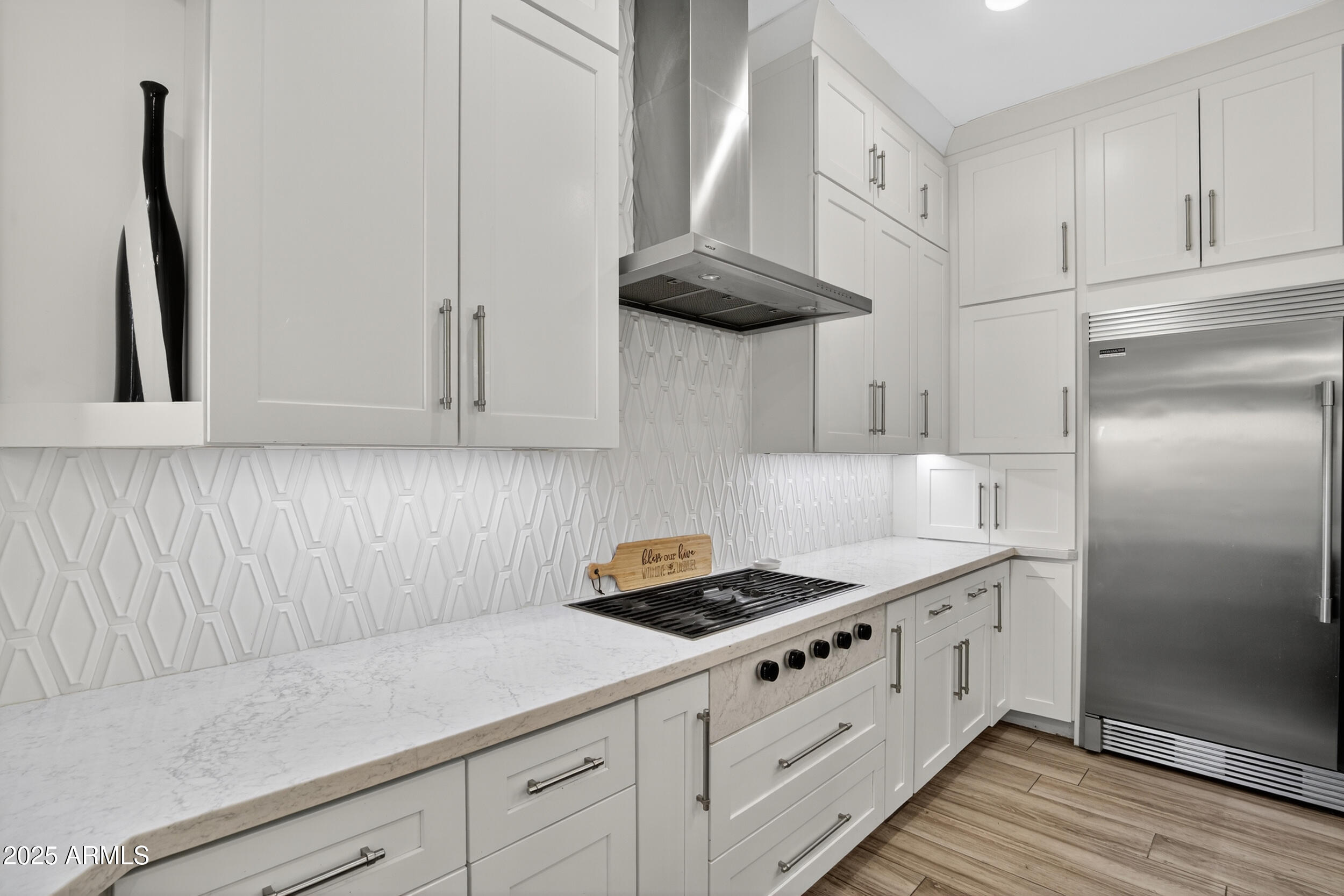 1333 North Cliffside Drive Gilbert, AZ 85234 - Photo 27 of 98 a kitchen with white cabinets a sink a stove and wooden floor