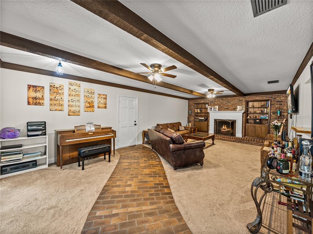 609 West Pipkin Road Lakeland, FL 33813 - Photo 26 of 72 a living room with furniture and a flat screen tv
