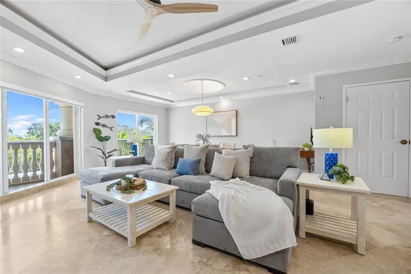 a living room with furniture and a view of kitchen