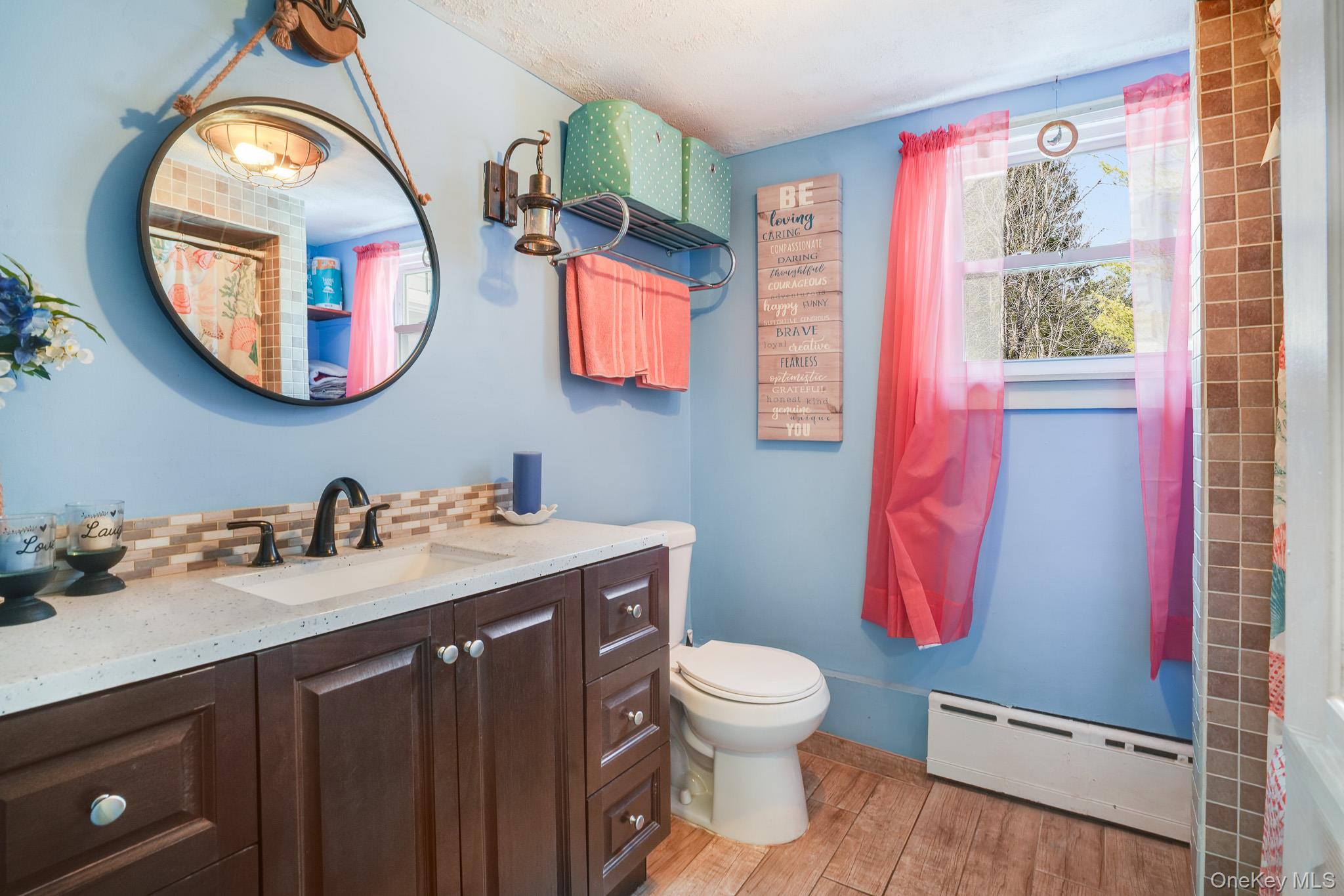 11 Gale Road Mongaup Valley, NY 12762 - Photo 17 of 39 a bathroom with a toilet a sink and a mirror