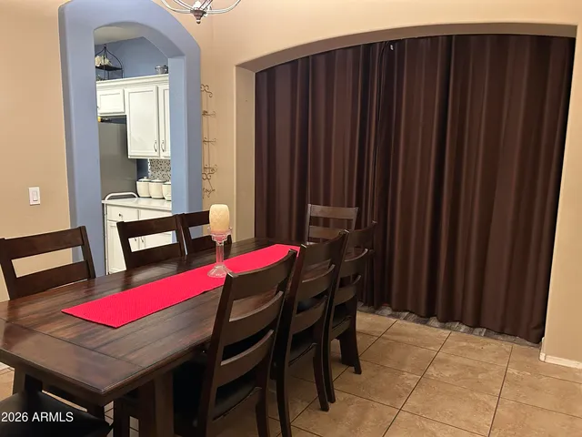 a bed room with a bed and painting on the wall