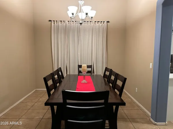 a view of a hallway with wooden floor and a living room