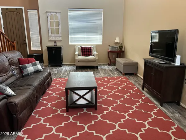 a view of a workspace with furniture and a window