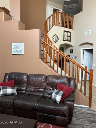 a living room with furniture and a ceiling fan