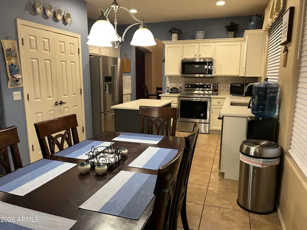 a kitchen with a table chairs stove and refrigerator