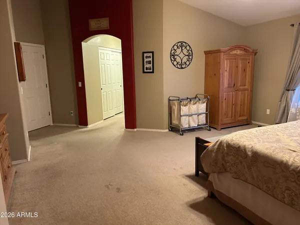 a bed room with a bed and painting on the wall