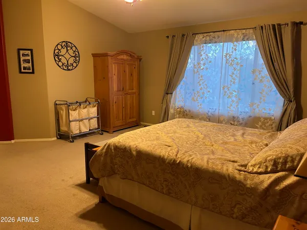 a bedroom with a bed and a dresser