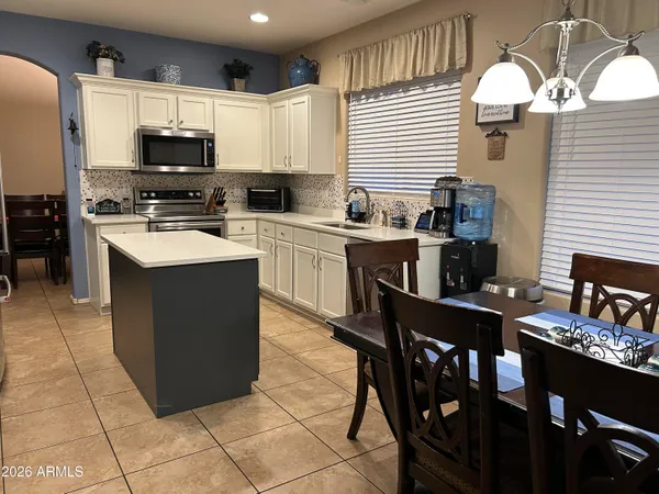 a kitchen with stainless steel appliances a stove sink microwave and cabinets