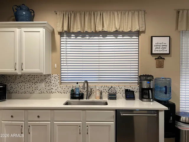 a bathroom with a sink and a shower curtain