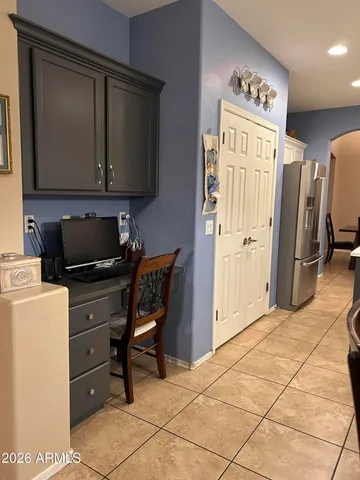 a spacious bedroom with a bed and a chandelier