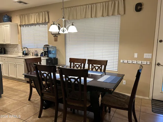 a bedroom with a bed and painting on the wall