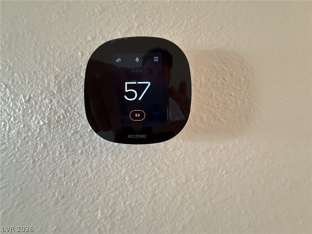 464 Box Canyon Road Alamo, NV 89001 - Photo 33 of 48 A modern smart thermostat on a textured wall regulates interior comfort.